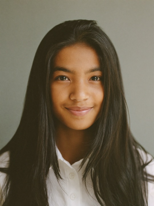 A young person smiling