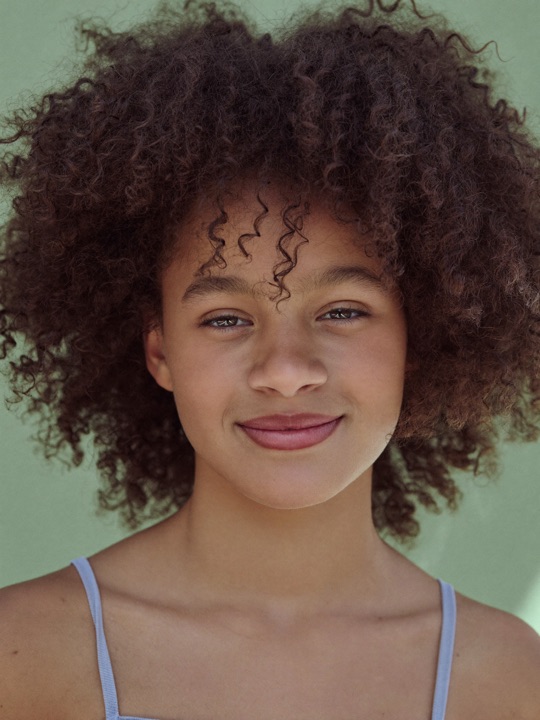 A young person smiling